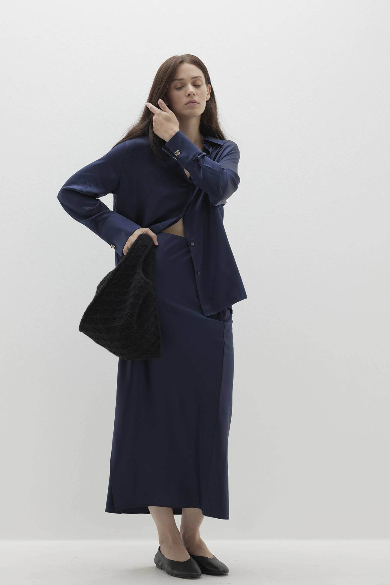 Model showcasing stylish navy outfit and bag from All Our Accessories collection.