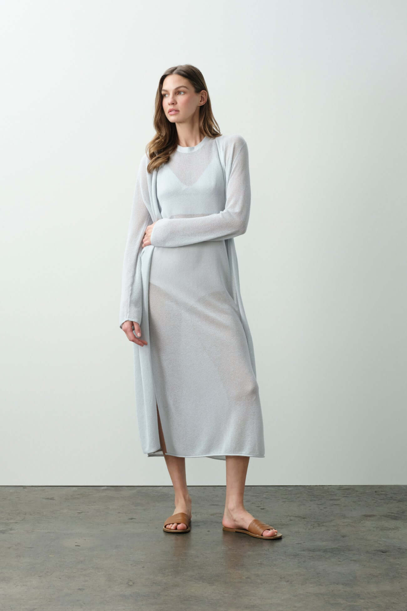 Model wearing a light blue cardigan with a long dress, showcasing the elegance of Cardigans in fashion.